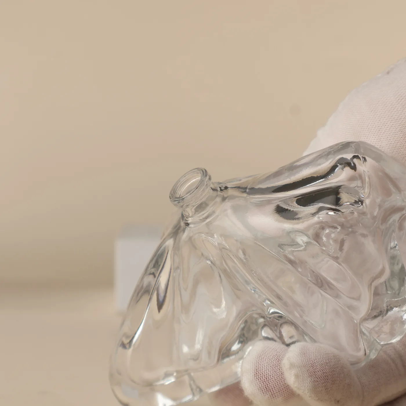 Neck and surface detail of the clear glass bottle