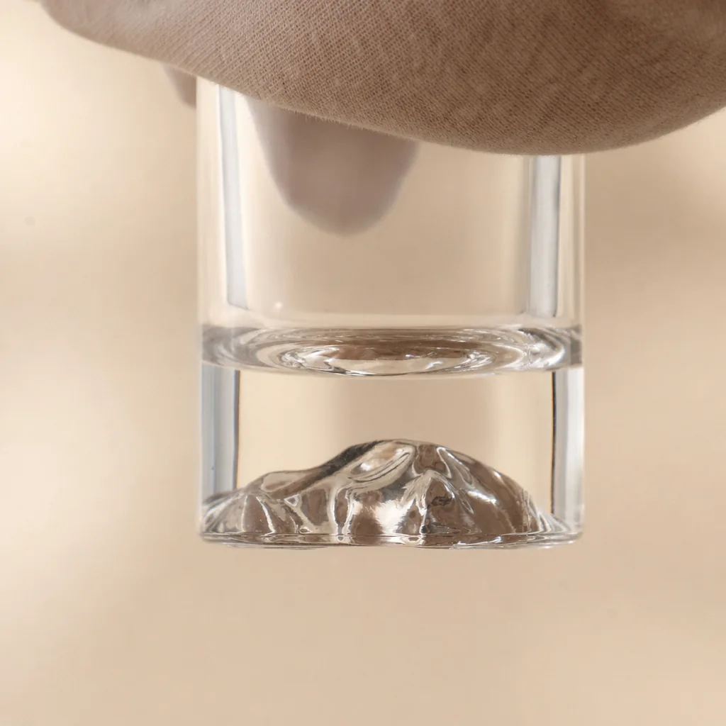 Close view of the mountain-like glass bottle base